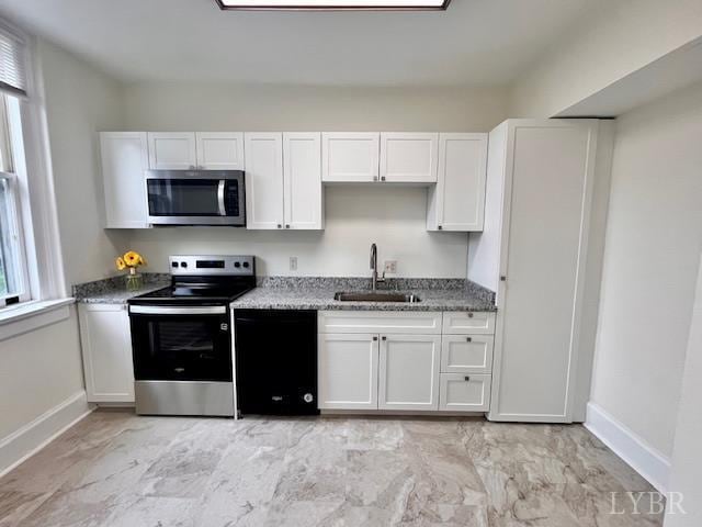 2910 Rivermont Ave Unit 301, Lynchburg, VA 24503 - kitchen with stainless steel appliances, a sink, baseboards, and white cabinets