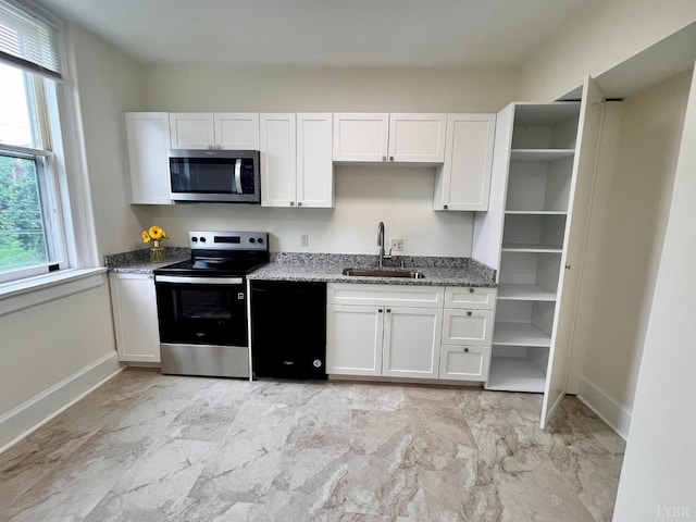 2910 Rivermont Ave Unit 301, Lynchburg, VA 24503 - kitchen with stainless steel appliances, a sink, light stone countertops, baseboards, and plenty of natural light