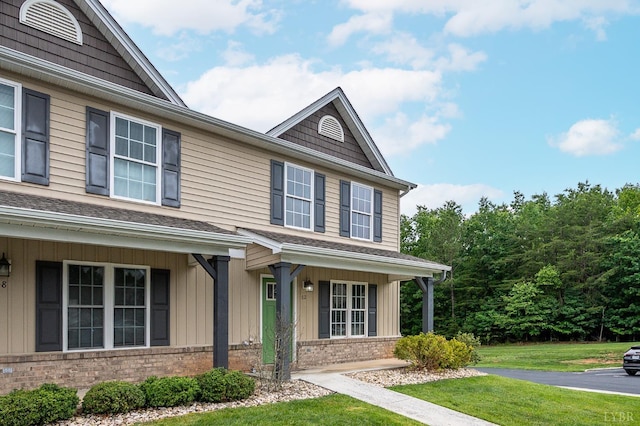 62 Squire Cir, Lynchburg, VA 24501 - view of front facade with brick siding, a front yard, board and batten siding, and a shingled roof