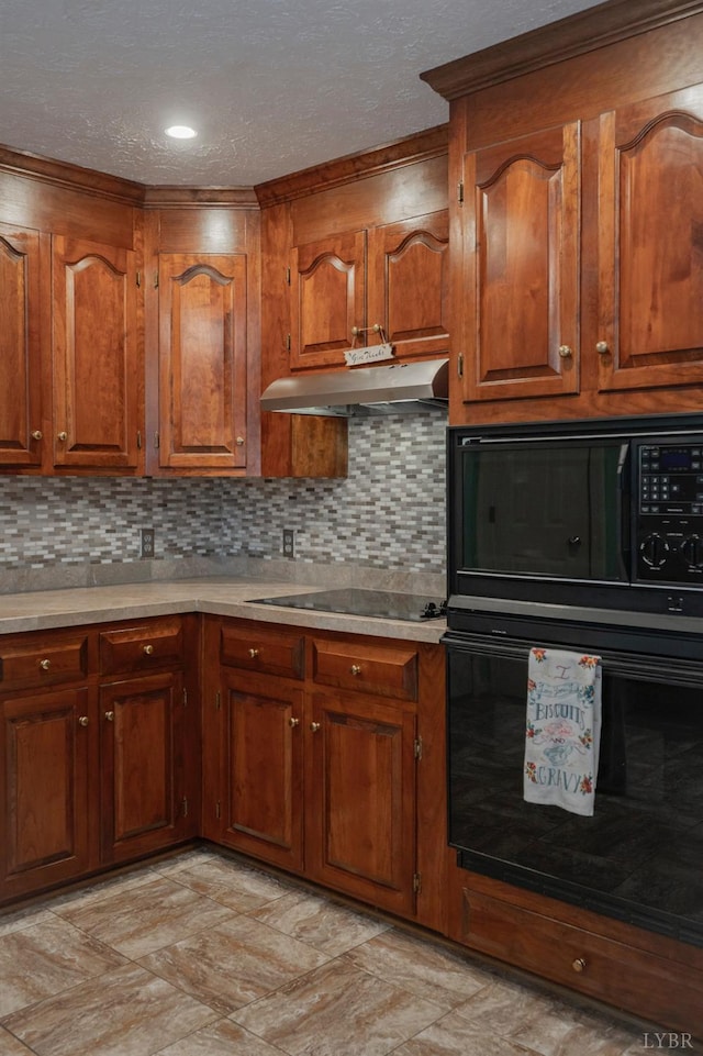220 Swan Ln, Forest, VA 24551 - kitchen with black appliances, under cabinet range hood, brown cabinetry, backsplash, and a textured ceiling