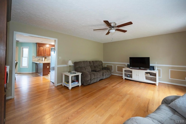 220 Swan Ln, Forest, VA 24551 - living room featuring a ceiling fan, light wood-style floors, and a textured ceiling
