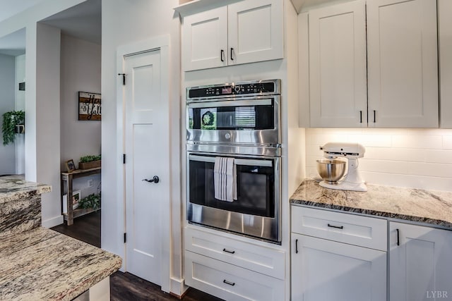 1151 Jefferson Meadows Dr, Forest, VA 24551 - kitchen featuring double oven, dark wood-style floors, backsplash, light stone countertops, and white cabinets