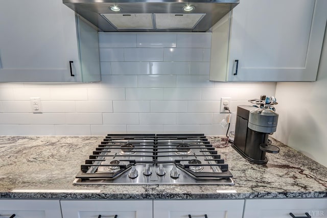 1151 Jefferson Meadows Dr, Forest, VA 24551 - kitchen with ventilation hood, stainless steel gas cooktop, backsplash, and light stone countertops