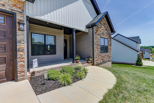 1151 Jefferson Meadows Dr, Forest, VA 24551 - doorway to property with a porch, stone siding, board and batten siding, and a lawn