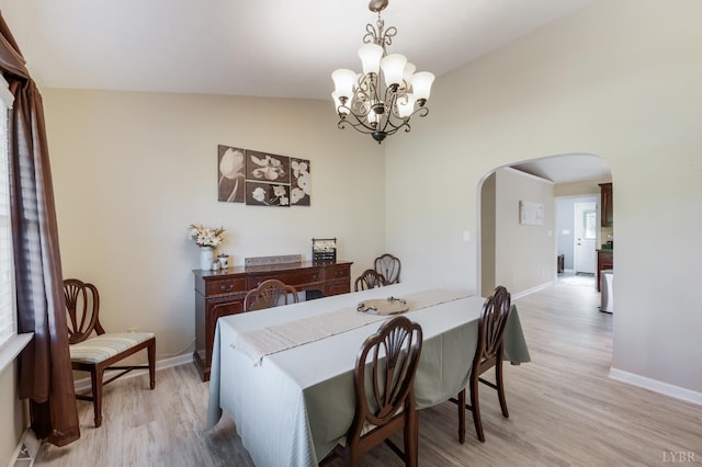 9790 Bear Creek Rd, Gladys, VA 24554 - dining space with arched walkways, light wood finished floors, a chandelier, and baseboards