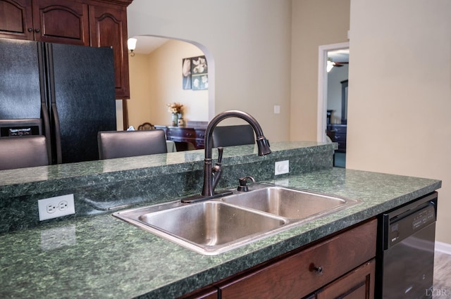 9790 Bear Creek Rd, Gladys, VA 24554 - kitchen featuring black appliances, dark countertops, arched walkways, and a sink