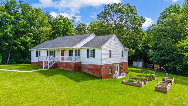 9790 Bear Creek Rd, Gladys, VA 24554 - single story home featuring a garden, covered porch, a front yard, roof with shingles, and view of wooded area