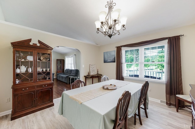 9790 Bear Creek Rd, Gladys, VA 24554 - dining room featuring arched walkways, plenty of natural light, vaulted ceiling, light wood-style floors, and crown molding