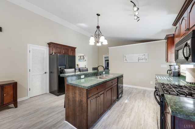 9790 Bear Creek Rd, Gladys, VA 24554 - kitchen featuring a sink, black appliances, dark countertops, a center island with sink, and light wood-style flooring