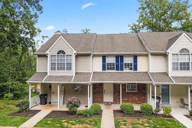 14 Jefferson Village Dr, Forest, VA 24551 - townhome / multi-family property featuring a porch, a chimney, a shingled roof, and brick siding