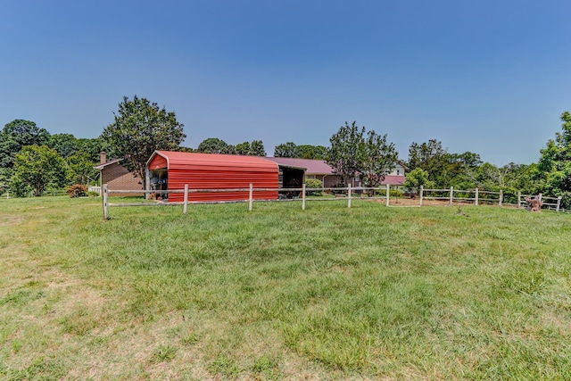 view of yard featuring an outdoor structure and an exterior structure