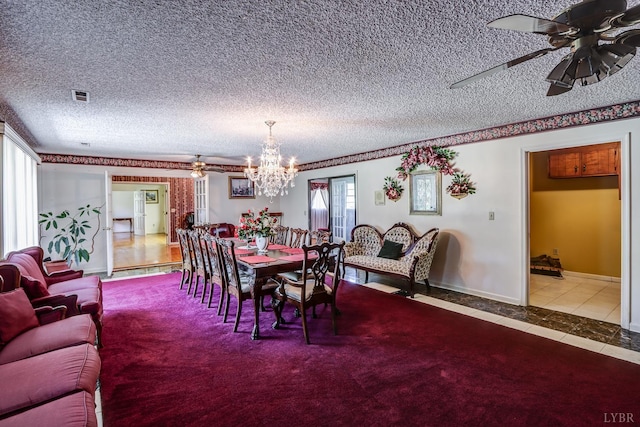 tiled dining room featuring a chandelier, a textured ceiling, and a ceiling fan