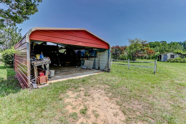 view of yard featuring a detached carport and an outdoor structure