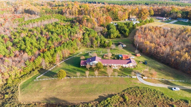 view of property location with a forest
