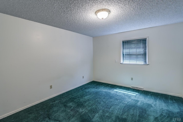 carpeted empty room with a textured ceiling and baseboards
