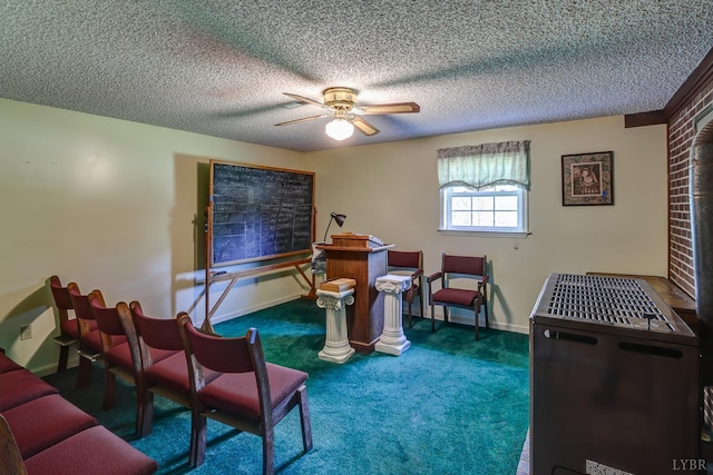 sitting room featuring a ceiling fan, carpet, and a textured ceiling