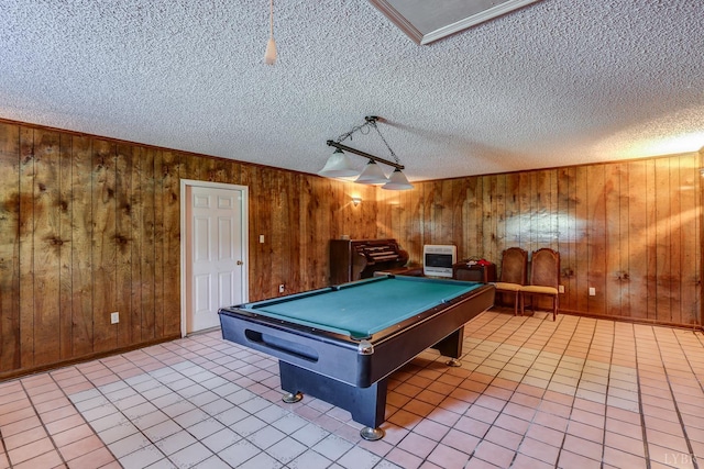 playroom with a textured ceiling, heating unit, wood walls, pool table, and light tile patterned flooring