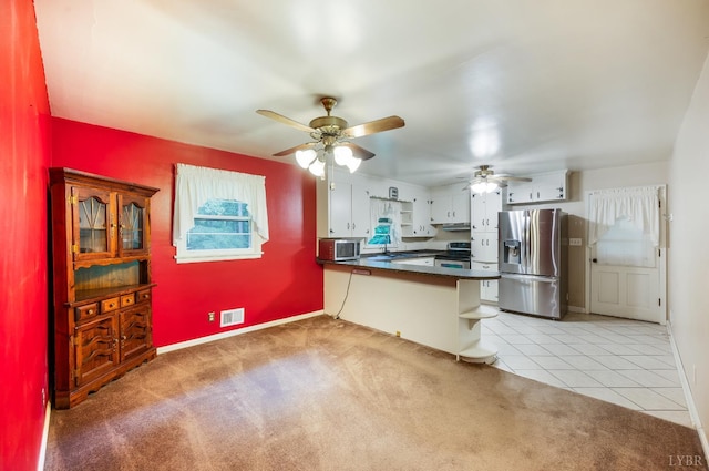 201 Oakland Cir, Lynchburg, VA 24502 - kitchen featuring appliances with stainless steel finishes, a peninsula, dark countertops, ceiling fan, and light carpet