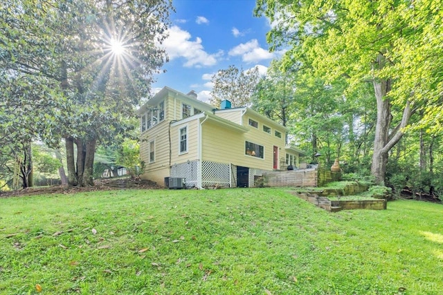 400 E Randolph Pl, Lynchburg, VA 24503 - view of side of home featuring a lawn, central air condition unit, a vegetable garden, and a chimney