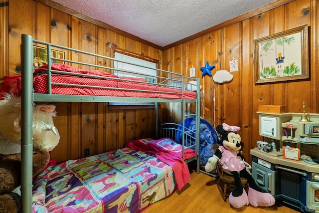 1703 Dale Ave, Altavista, VA 24517 - bedroom featuring wooden walls, wood finished floors, a textured ceiling, and crown molding
