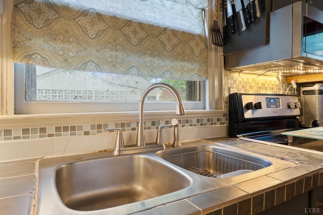 1703 Dale Ave, Altavista, VA 24517 - kitchen view of a sink and tasteful backsplash
