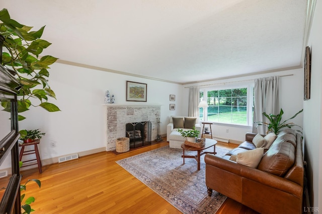 921 Peaksview St, Bedford, VA 24523 - living area featuring light wood-style floors, a brick fireplace, baseboards, and crown molding