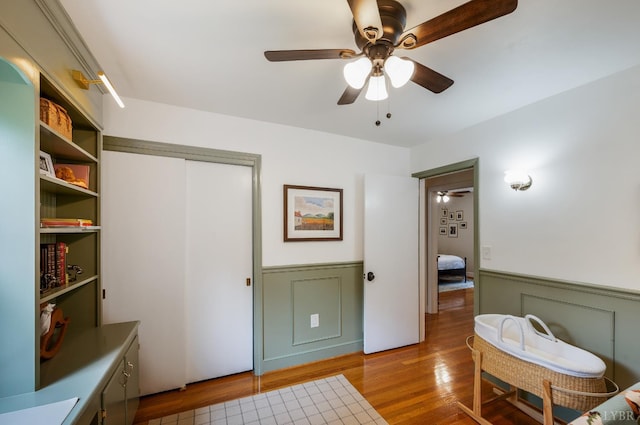 921 Peaksview St, Bedford, VA 24523 - bedroom with wainscoting, wood finished floors, a ceiling fan, and a closet