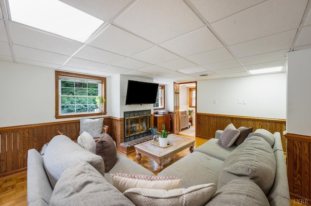 921 Peaksview St, Bedford, VA 24523 - living room with a wainscoted wall, wood walls, a drop ceiling, and a glass covered fireplace