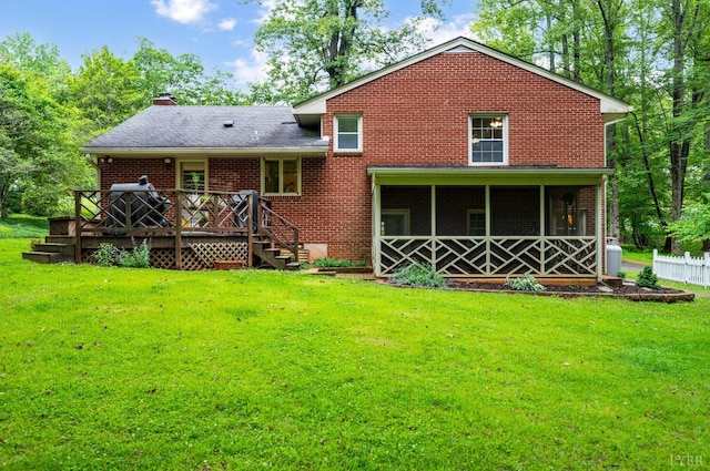 921 Peaksview St, Bedford, VA 24523 - rear view of property with a chimney, a yard, a wooden deck, brick siding, and a sunroom