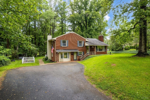 921 Peaksview St, Bedford, VA 24523 - view of front of property featuring a chimney, brick siding, driveway, and a front lawn