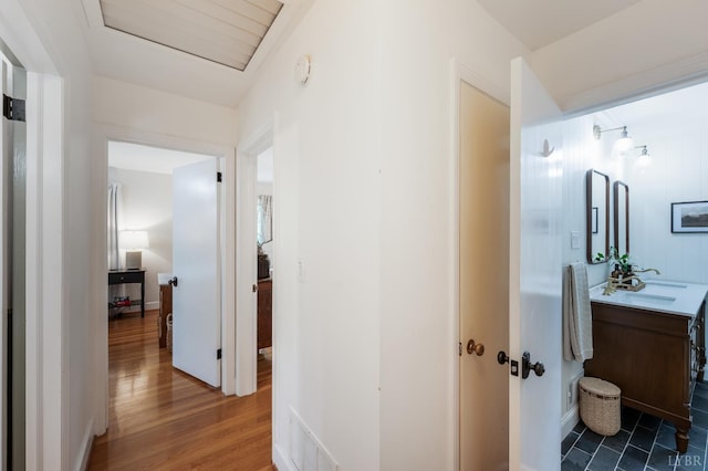 921 Peaksview St, Bedford, VA 24523 - hallway featuring attic access, a sink, and wood finished floors