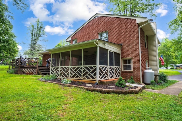 921 Peaksview St, Bedford, VA 24523 - back of house with a sunroom, a lawn, a deck, a chimney, and brick siding
