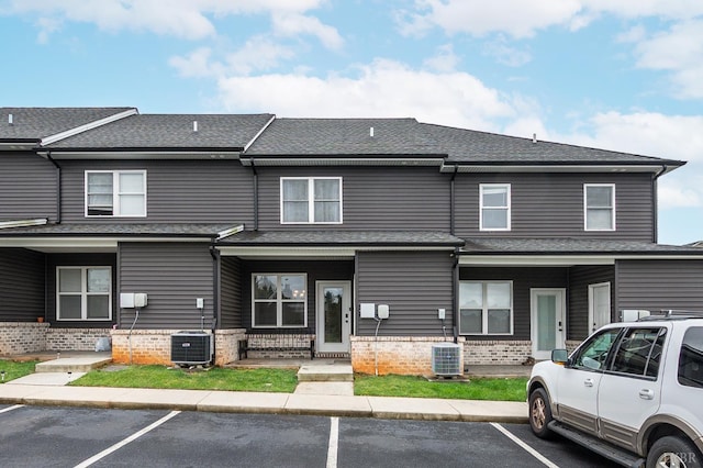 213 Capstone Dr, Lynchburg, VA 24502 - townhome / multi-family property featuring uncovered parking, brick siding, roof with shingles, and cooling unit
