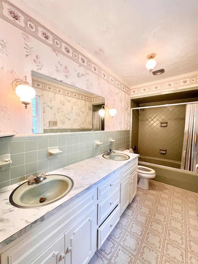 166 Matohe Rd, Monroe, VA 24574 - bathroom featuring tile walls, double vanity, shower / bathtub combination, tile patterned floors, and wainscoting