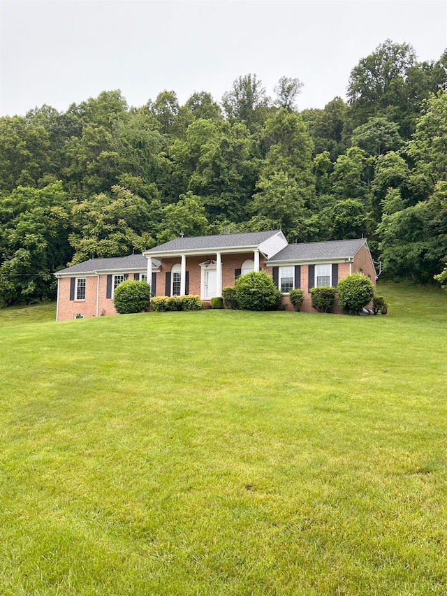166 Matohe Rd, Monroe, VA 24574 - single story home featuring a front lawn, brick siding, and a wooded view