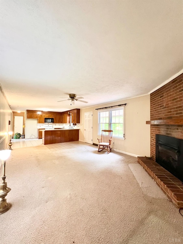 166 Matohe Rd, Monroe, VA 24574 - unfurnished living room with light colored carpet, a fireplace, a ceiling fan, and crown molding