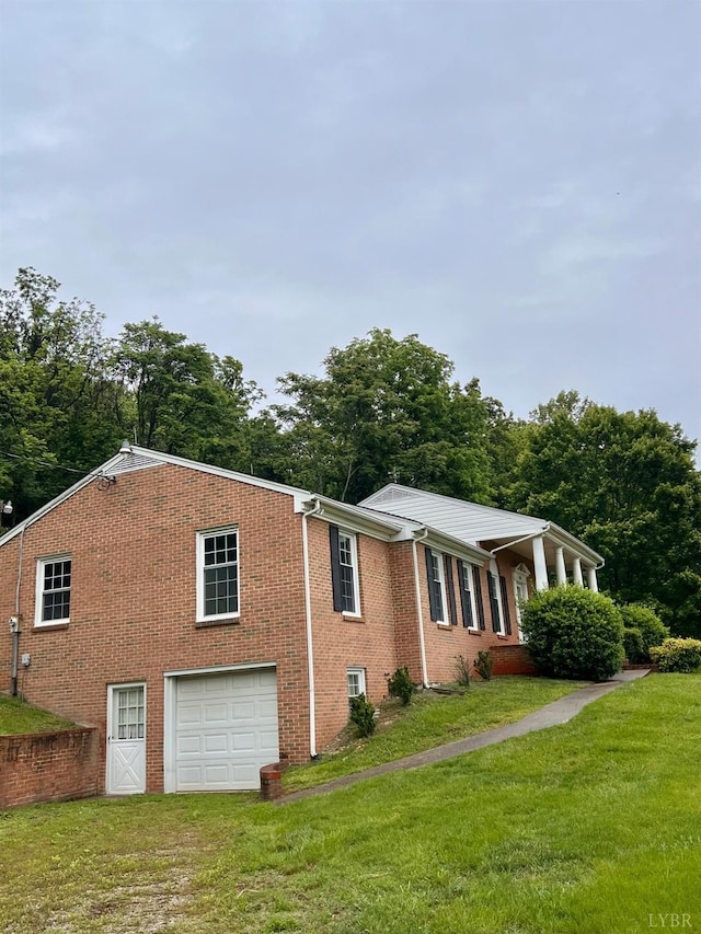 166 Matohe Rd, Monroe, VA 24574 - view of side of property featuring an attached garage, a lawn, driveway, and brick siding