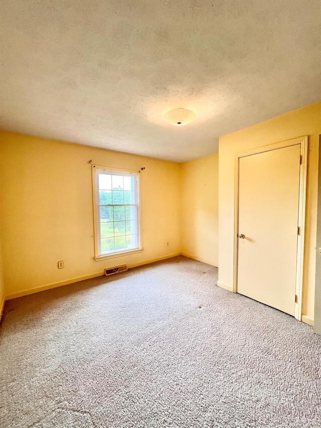 166 Matohe Rd, Monroe, VA 24574 - empty room with light colored carpet and a textured ceiling