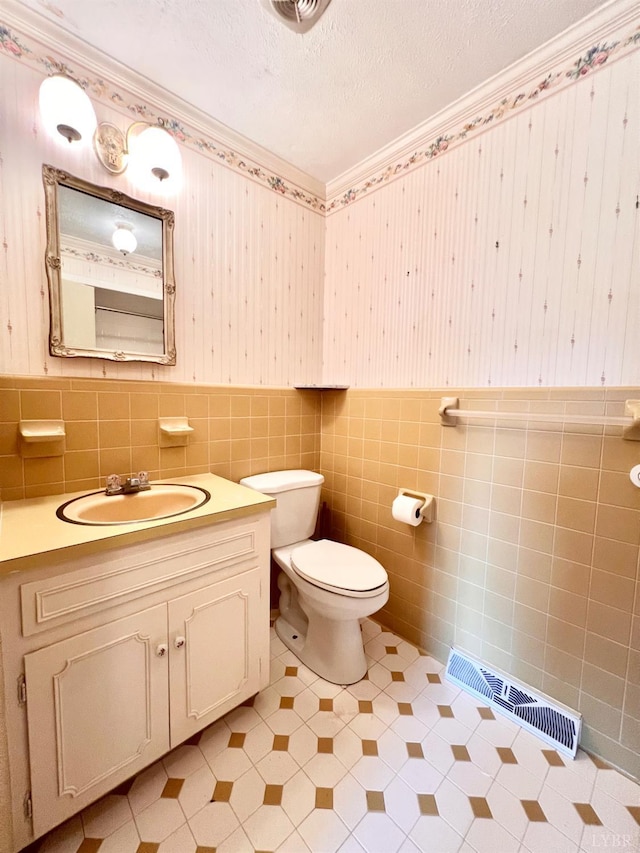 166 Matohe Rd, Monroe, VA 24574 - half bathroom featuring vanity, crown molding, tile walls, wainscoting, and a textured ceiling