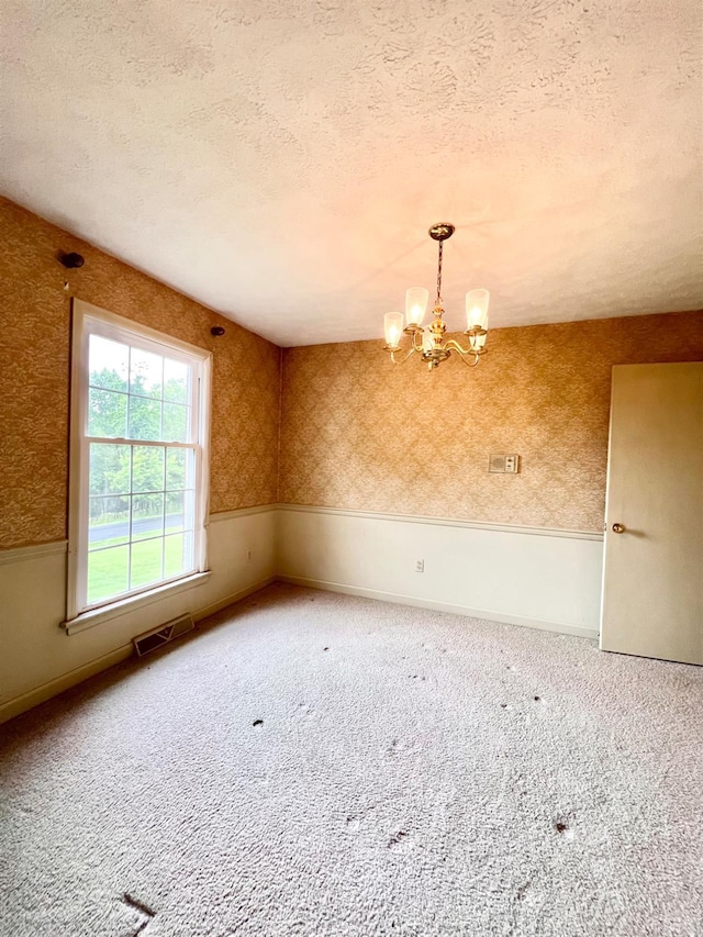 166 Matohe Rd, Monroe, VA 24574 - unfurnished room featuring a chandelier, carpet flooring, a textured ceiling, and wallpapered walls