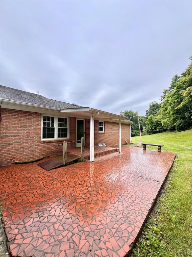 166 Matohe Rd, Monroe, VA 24574 - back of property featuring a patio area, brick siding, a lawn, and a shingled roof