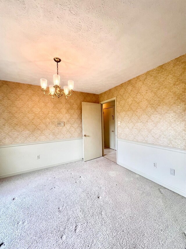 166 Matohe Rd, Monroe, VA 24574 - carpeted empty room featuring a chandelier and a textured ceiling