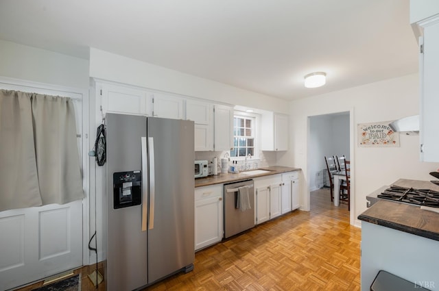 6012 Rhonda Rd, Lynchburg, VA 24502 - kitchen featuring stainless steel appliances, a sink, white cabinets, and ventilation hood
