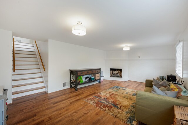 6012 Rhonda Rd, Lynchburg, VA 24502 - living room featuring a fireplace with raised hearth, stairway, wood finished floors, and baseboards