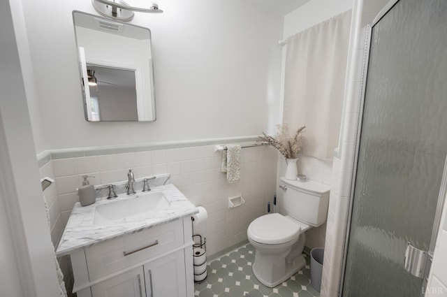 6012 Rhonda Rd, Lynchburg, VA 24502 - full bath with a stall shower, vanity, toilet, a wainscoted wall, and tile walls