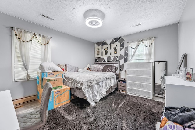 2523 Clarks Rd, Rustburg, VA 24588 - bedroom with baseboard heating and a textured ceiling
