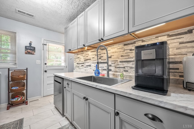 2523 Clarks Rd, Rustburg, VA 24588 - kitchen with decorative backsplash, stainless steel dishwasher, gray cabinetry, and a textured ceiling