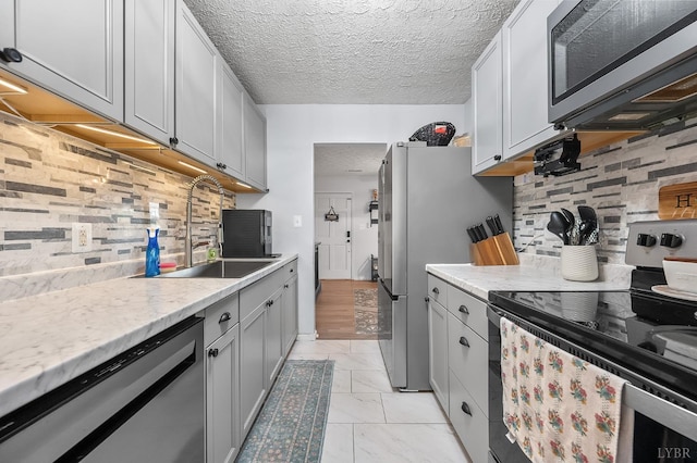 2523 Clarks Rd, Rustburg, VA 24588 - kitchen featuring appliances with stainless steel finishes, light countertops, backsplash, a textured ceiling, and gray cabinetry