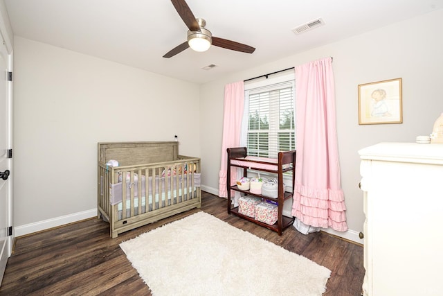 1480 Pilgrim Rd, Goode, VA 24556 - bedroom with wood finished floors, baseboards, ceiling fan, and a crib