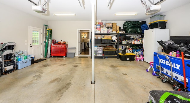 1480 Pilgrim Rd, Goode, VA 24556 - garage with freestanding refrigerator and a garage door opener